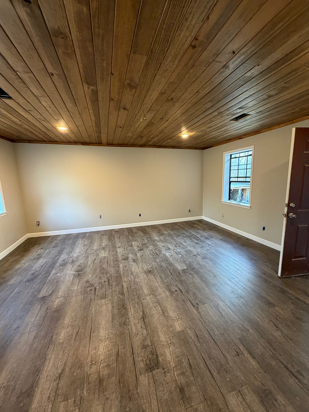 Living room remodel with new wood-look flooring and wood plank ceiling