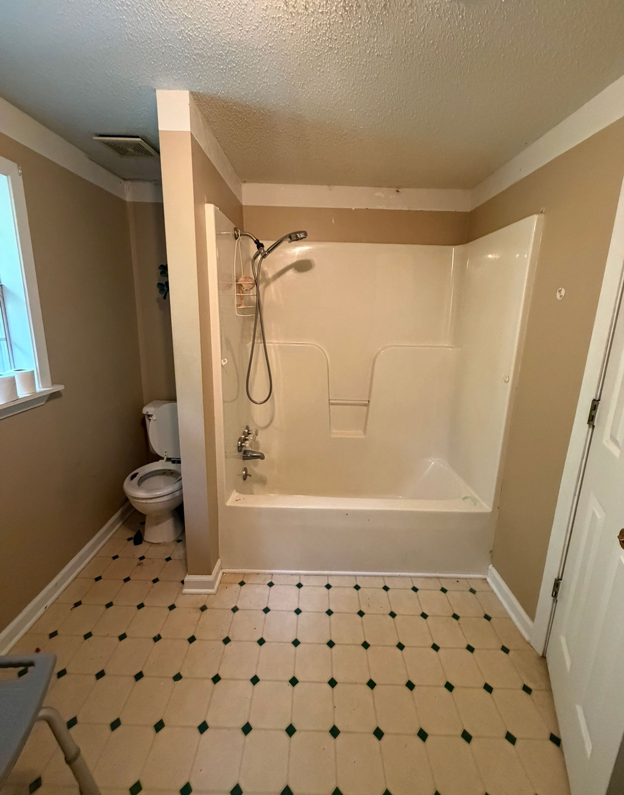 Bathroom before remodel with tub and shower surround